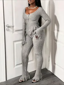 Detailed view of grey ribbed knit set featuring stylish fringe tassels on hem and cuffs