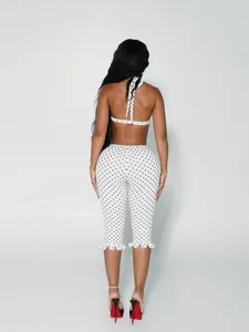 Detailed back view of a stylish polka dot two-piece outfit with feminine ruffle hems.