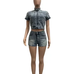 Detail of two-piece washed denim set with crop zip top and slim shorts