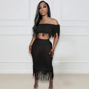 Detailed view of a sexy black crochet mesh two-piece beach set featuring fringe tassels