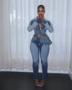 Stylish women's spliced contrast wash denim jacket and pants two-piece set on a model
