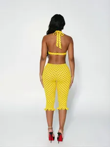 Rear view detail of yellow polka dot two-piece halter top and cropped leggings set