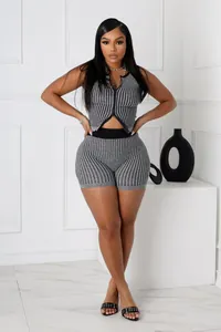 Detail of women's knit 2-piece set featuring a two-way zipper striped vest and shorts