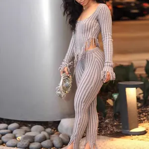 Full view of sexy gray striped knitted two-piece set featuring trendy fringed hems and cuffs