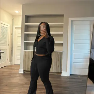 Full body view of a woman wearing a chic black knitted two-piece leisure lounge set.