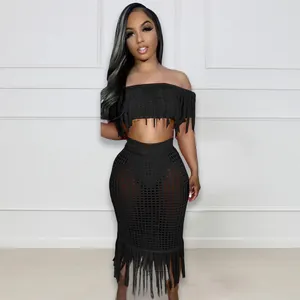 Detailed view of a stylish black hand-crocheted fringe beach set on a female model