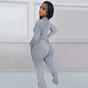 Rear view of woman in grey ribbed knitted sweater and matching pants fashion set
