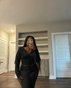 Close-up detail of women's black knitted sweater tracksuit set in casual selfie view