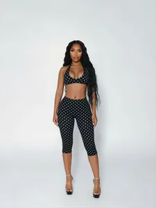 Sexy black and white polka dot two-piece fashion set with halter top and cropped leggings