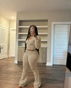 Detailed view of beige knit two-piece set featuring cropped hoodie and flare pants