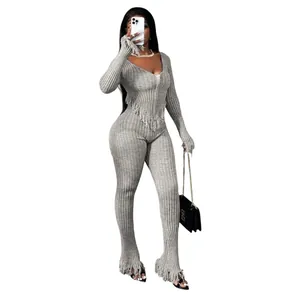 Sexy grey ribbed knit jumpsuit featuring hand-hooked fringe details and V-neckline
