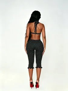Back view of sexy black and white polka dot two-piece halter top and cropped pants set