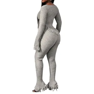 Detailed side view of grey ribbed knitted two-piece set featuring stylish fringe tassels