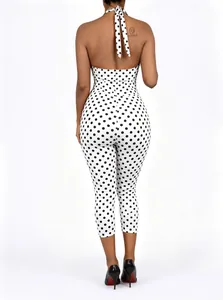 Back view of a chic polka dot halter neck jumpsuit with a stylish tie-back design.