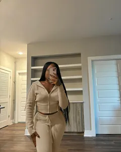 Chic beige knitted two-piece tracksuit set for women shown in a cozy home mirror selfie