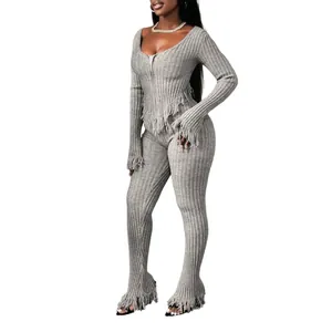 Stylish grey two-piece knitted lounge set featuring fringe detail and flared pants