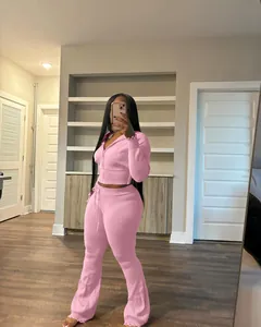 Detailed look at pink knitted two-piece set with zip-up hoodie and flare pants.