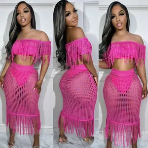 Detail shot of a sexy fuchsia crochet knit fringe two-piece beach set shown on a model.