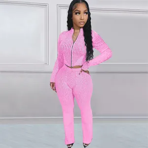 Detail view of pink knit two-piece set featuring a two-way zip-up top and matching pants