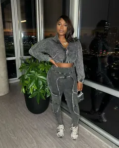 Close-up of women's acid wash distressed patchwork two-piece set with urban night view background
