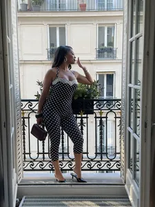 Stylish black and white polka dot halter jumpsuit featuring elegant white lace trim