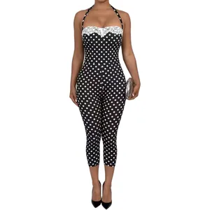 Fashionable polka dot jumpsuit featuring elegant lace trim and a sexy halter neck design