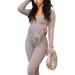 Detail of sexy striped knit two-piece set with fringe hem and matching pants