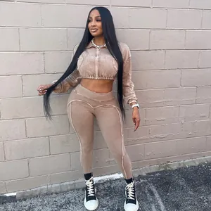 Fashion model in washed ribbed two-piece leisure set standing against a brick wall