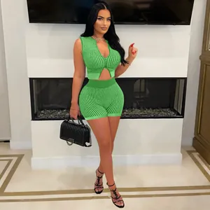 Green knitted two-piece set with two-way zipper top and matching shorts worn by model