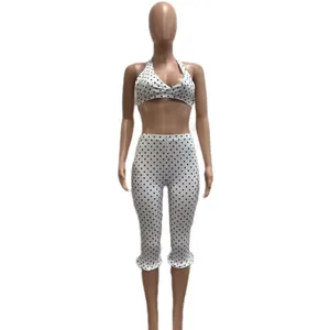 Stylish white and black polka dot two-piece casual set with halter top and capri pants
