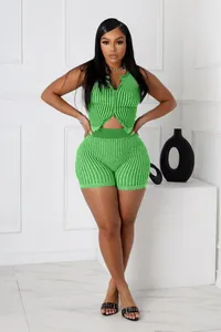 Full view of women's vibrant green two-piece ribbed knit set with zipper top