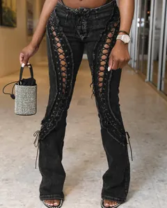 Detailed shot of high-waist black jeans featuring double front lace-up eyelet style