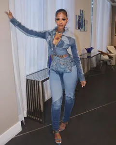 Stylish women's two-piece patchwork denim set featuring high-waisted pants and a cropped jacket.
