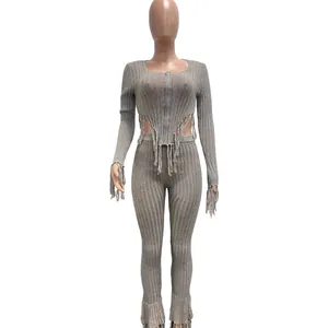 Women's two-piece grey knit set featuring a zip-up top with fringe and ribbed leggings.