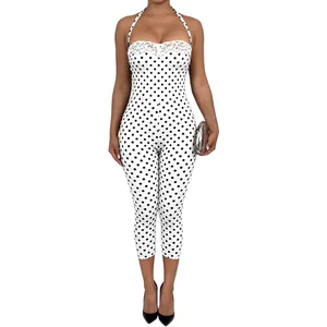 Detail view of a white polka dot halter jumpsuit featuring elegant white lace trim