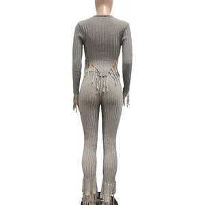 Back view of sexy grey ribbed knit two-piece set with long sleeves and fringe detailing