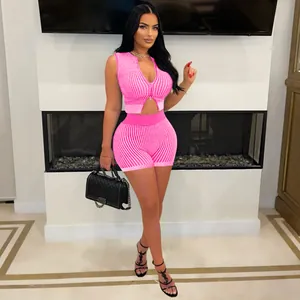 Close-up detail of women's pink and white striped knit two-piece set featuring two-way zipper