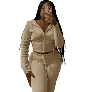 Detail view of khaki two-piece knitted sports set featuring cropped zip hoodie and pants.
