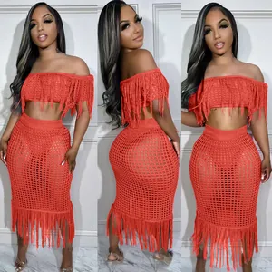 Close-up detail of the red off-shoulder crochet knit top and matching fringe skirt set.