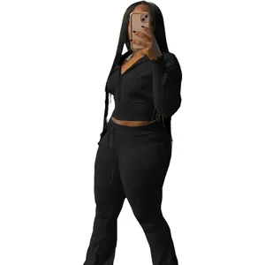 Close-up detail of a women's black ribbed knit two-piece sports set with a zip-up hoodie