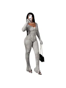 Elegant grey knitted two-piece outfit featuring fringe trim and flared leggings