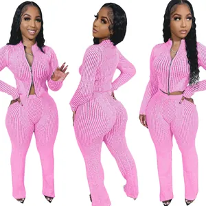 Detailed view of women's pink ribbed knit two-piece set featuring two-way zipper top