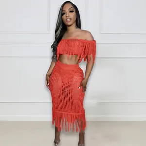 Orange crochet two-piece set with fringe details and off-the-shoulder hollow-out design