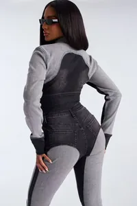 Back view of a chic two-piece washed denim set with black and grey patchwork detail
