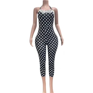 Close-up of polka dot jumpsuit with lace trim and halter neck detail on mannequin
