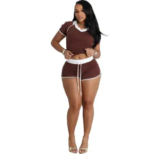Detail view of a two-piece brown yoga sportswear set featuring V-neck and white trim accents