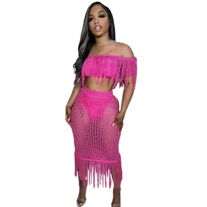 Two-piece pink knit sexy beach set featuring fringe off-shoulder top and matching midi skirt