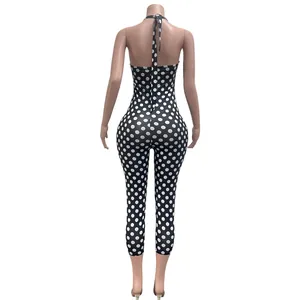 Back view of a sexy black and white polka dot halter neck jumpsuit for women outfit