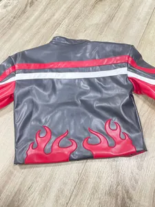 Vue détaillée du dos d'un blouson de motard noir avec broderie de flammes rouges et rayures.