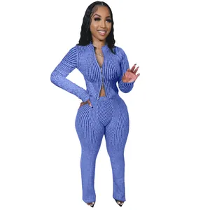 Close-up detail of a blue ribbed knit two-piece set featuring a stylish two-way zipper
